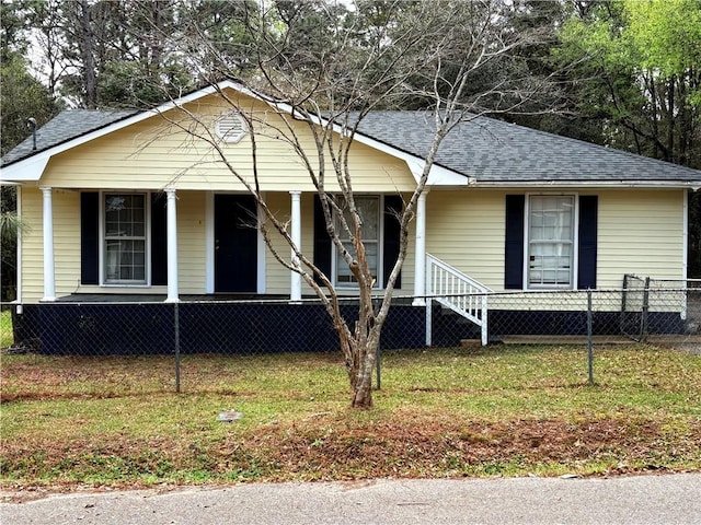 view of front of house with a fenced front yard, roof with shingles, and covered porch