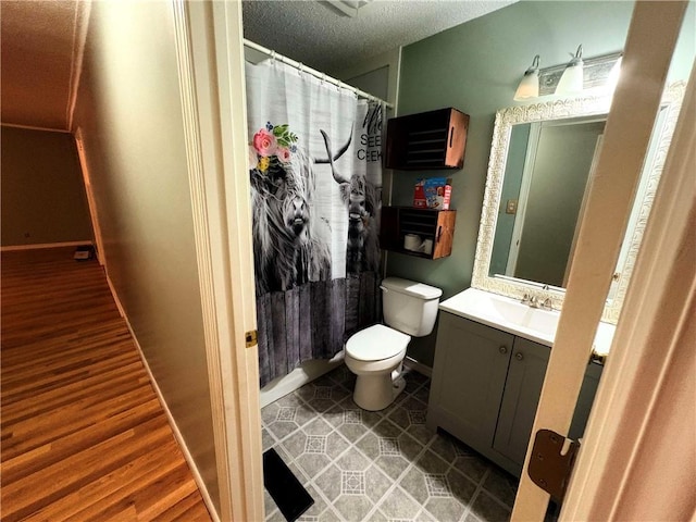 full bath with vanity, toilet, wood finished floors, and baseboards