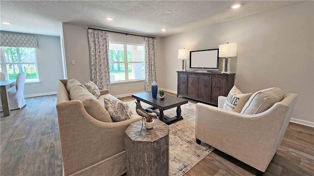 living room featuring a textured ceiling and dark wood-type flooring