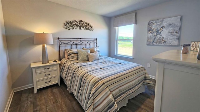 bedroom with dark hardwood / wood-style flooring