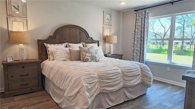 bedroom with dark hardwood / wood-style floors