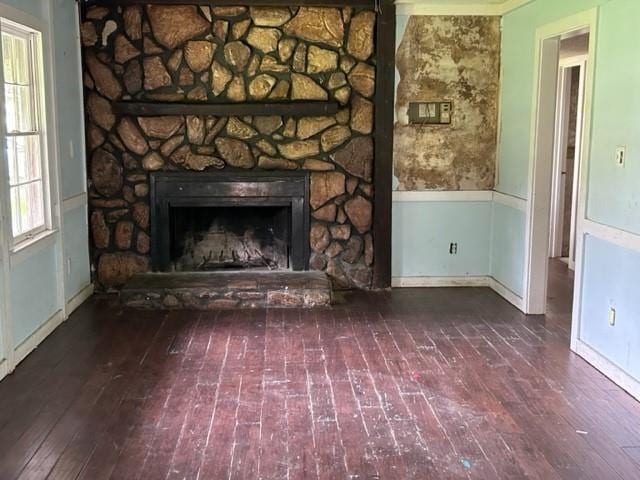 unfurnished living room featuring a stone fireplace