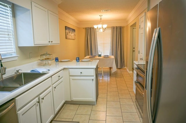 8470 Desert Oak Ct, Mobile, AL 36695 - kitchen featuring stainless steel appliances, crown molding, a chandelier, white cabinetry, and a sink