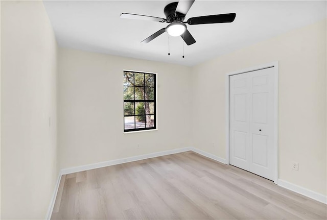 unfurnished bedroom with a closet, ceiling fan, and light wood-type flooring