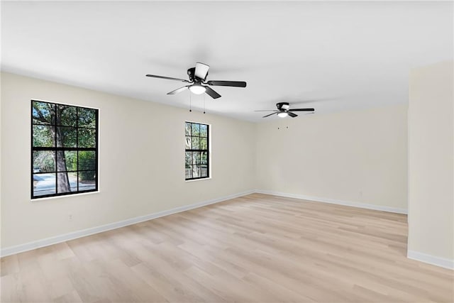 unfurnished room with ceiling fan and light wood-type flooring