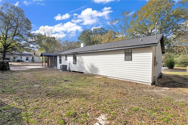 view of side of home with central AC