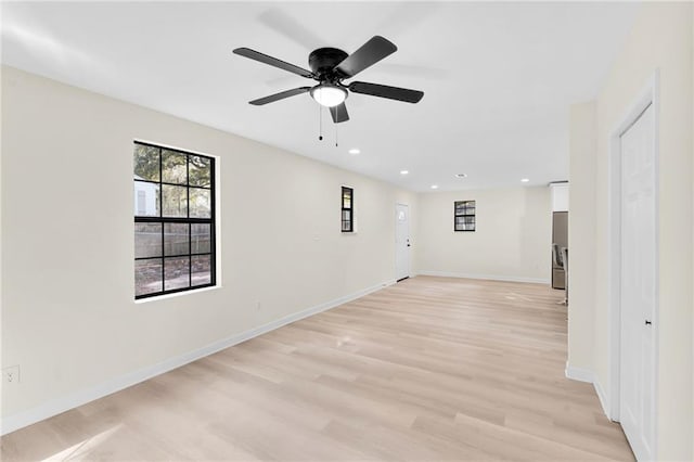 spare room featuring ceiling fan and light hardwood / wood-style floors