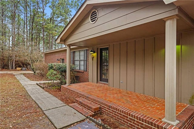 doorway to property featuring brick siding