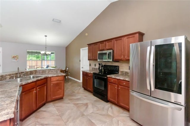 10234 Scott Plantation Dr N, Mobile, AL 36695 - kitchen with stainless steel appliances, brown cabinets, a chandelier, pendant lighting, and high vaulted ceiling