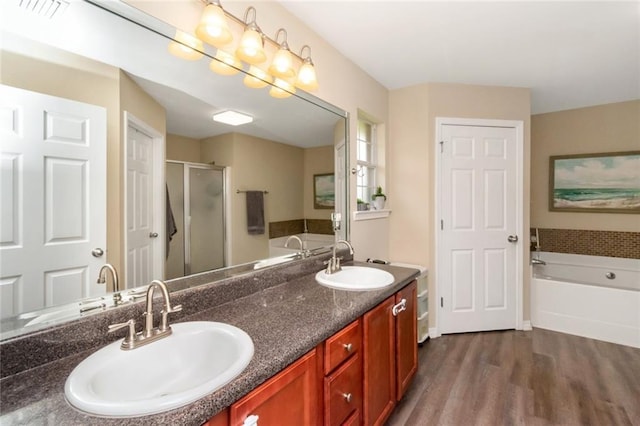 10234 Scott Plantation Dr N, Mobile, AL 36695 - bathroom featuring a bath, wood finished floors, a shower stall, and double vanity