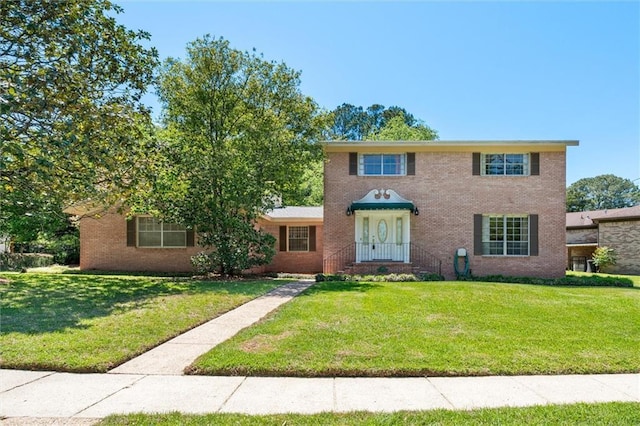 view of front of house featuring brick siding and a front lawn
