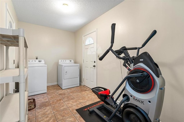 laundry area featuring separate washer and dryer, laundry area, and a textured ceiling