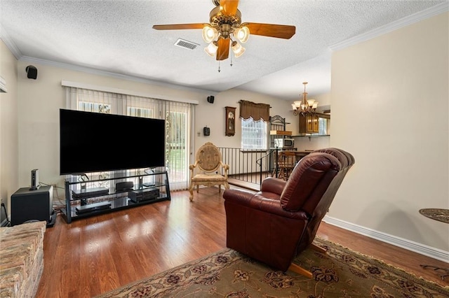 living room with visible vents, wood finished floors, and a textured ceiling