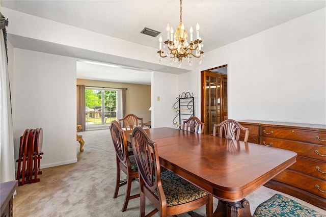 dining room with baseboards, light colored carpet, a notable chandelier, and visible vents