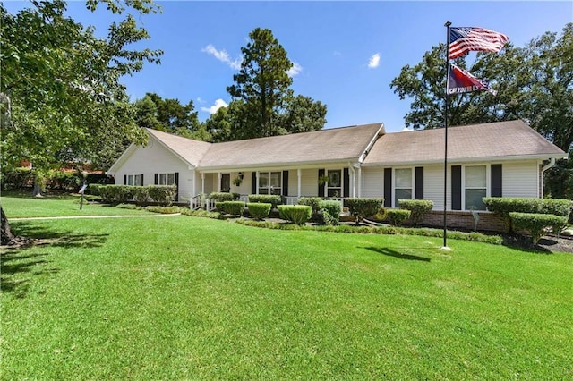 single story home featuring a porch and a front yard