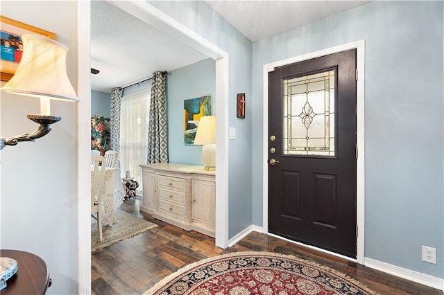 entryway featuring dark wood-style floors and baseboards