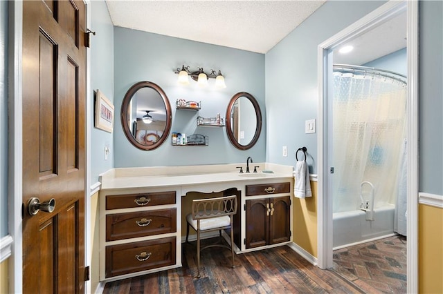 full bathroom with baseboards, wood finished floors, shower / bath combination with curtain, and vanity