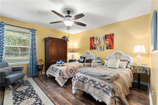 bedroom featuring a textured ceiling, wood finished floors, ceiling fan, and baseboards