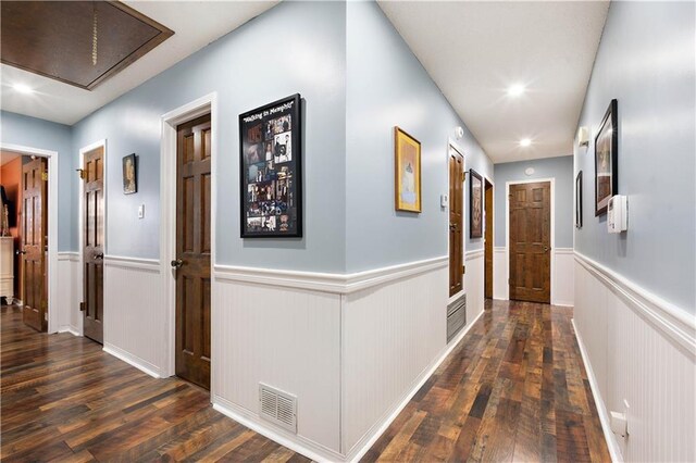 hall featuring visible vents, attic access, recessed lighting, wood finished floors, and wainscoting