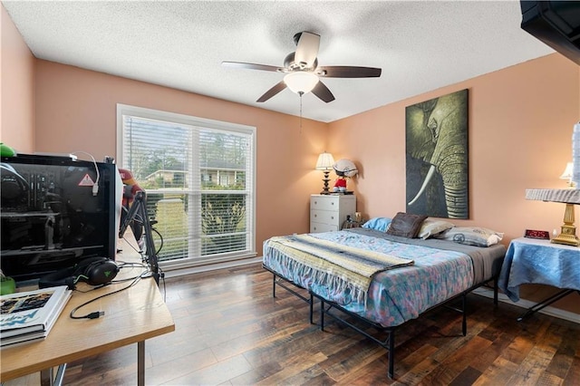 bedroom featuring a textured ceiling, wood finished floors, and ceiling fan