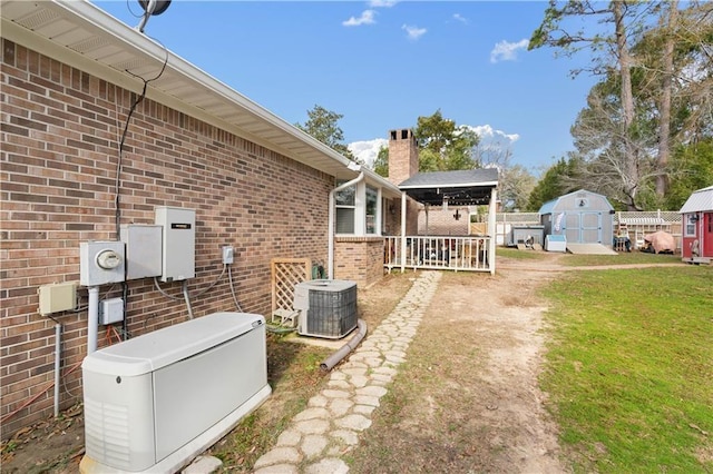 view of yard with an outdoor structure, central air condition unit, and a shed