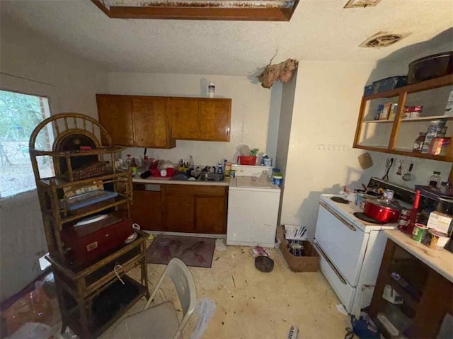 kitchen with washer / dryer and a textured ceiling