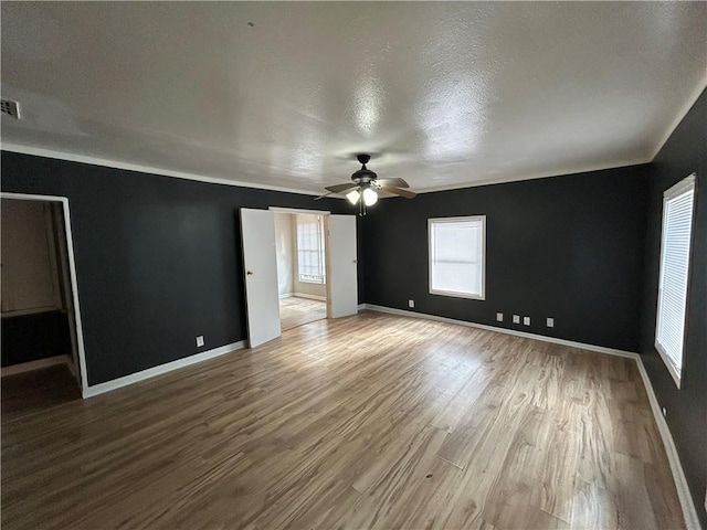 interior space featuring ceiling fan, hardwood / wood-style floors, and a textured ceiling