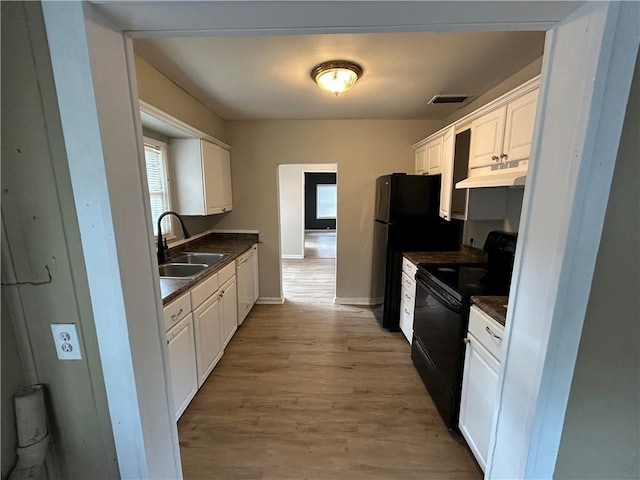 kitchen with white cabinets, dishwasher, sink, and black electric range