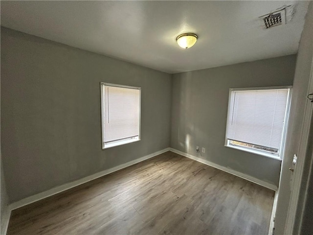 empty room with wood-type flooring