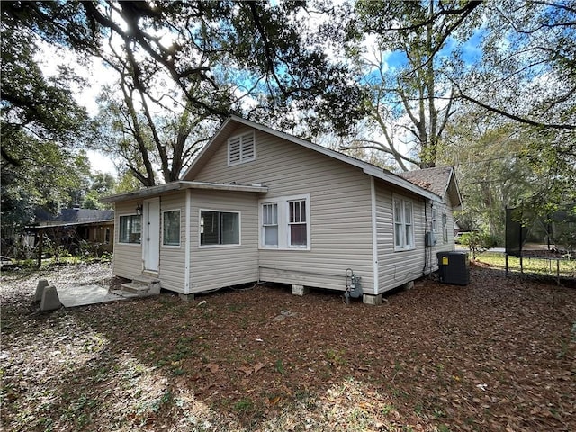 rear view of house featuring central air condition unit