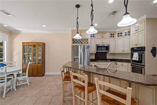 9791 Aspen Cir, Daphne, AL 36527 - kitchen featuring appliances with stainless steel finishes, a kitchen bar, glass insert cabinets, crown molding, and hanging light fixtures
