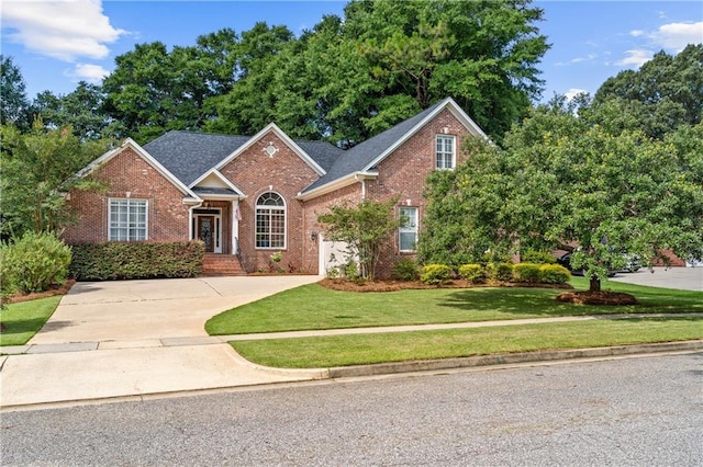 9791 Aspen Cir, Daphne, AL 36527 - traditional-style house featuring brick siding, a front yard, and driveway