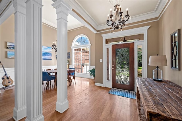 9791 Aspen Cir, Daphne, AL 36527 - entryway featuring decorative columns, a chandelier, wood finished floors, and crown molding