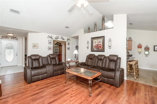 living room featuring ceiling fan, lofted ceiling, and hardwood / wood-style floors