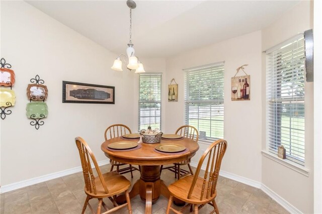 dining space with plenty of natural light, a chandelier, and light tile patterned floors