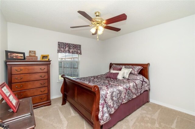 bedroom featuring ceiling fan and light carpet