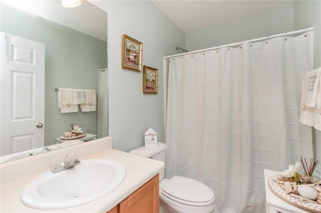 bathroom featuring toilet and vanity