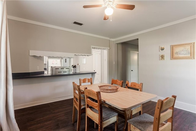 dining space with ceiling fan, crown molding, and dark hardwood / wood-style floors