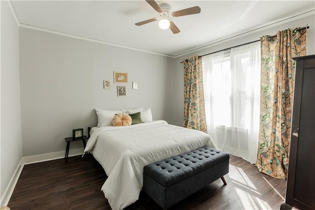 bedroom featuring ornamental molding, dark wood-type flooring, and ceiling fan