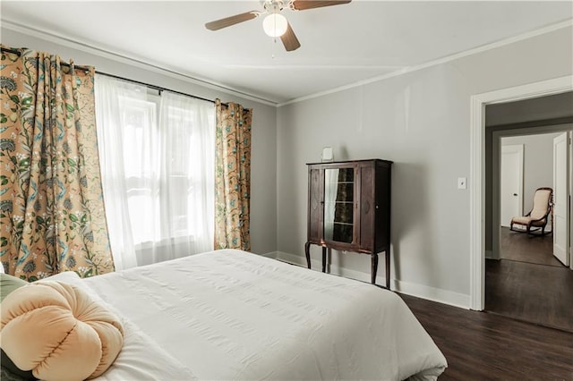 bedroom featuring ceiling fan, ornamental molding, and dark hardwood / wood-style flooring