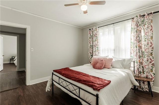 bedroom with ceiling fan, ornamental molding, and dark hardwood / wood-style flooring