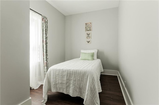 bedroom with dark wood-type flooring