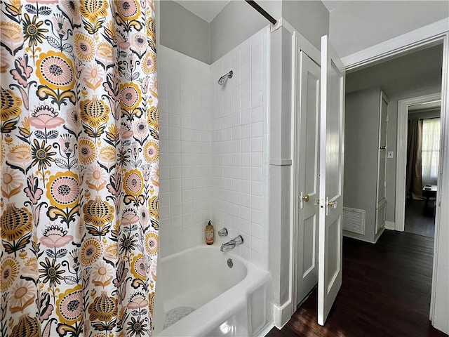 bathroom featuring shower / tub combo and wood-type flooring