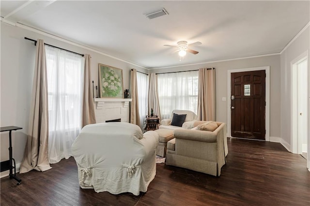 living room featuring crown molding, ceiling fan, dark hardwood / wood-style floors, and plenty of natural light