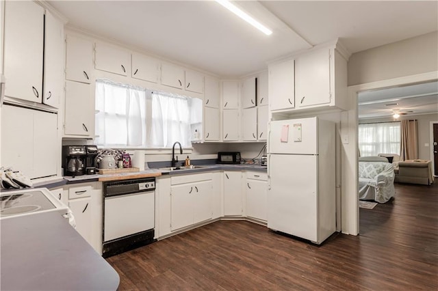 kitchen featuring sink, white cabinets, and white appliances