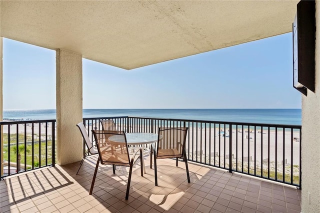 balcony with a water view and a beach view