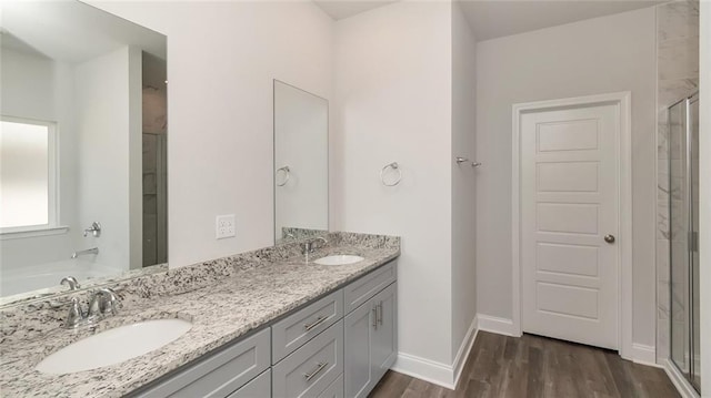 9836 Nadine Ln S, Mobile, AL 36695 - bathroom featuring a stall shower, double vanity, wood finished floors, and a tub