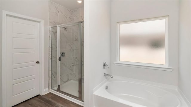 9836 Nadine Ln S, Mobile, AL 36695 - bathroom featuring a garden tub, a stall shower, and wood finished floors