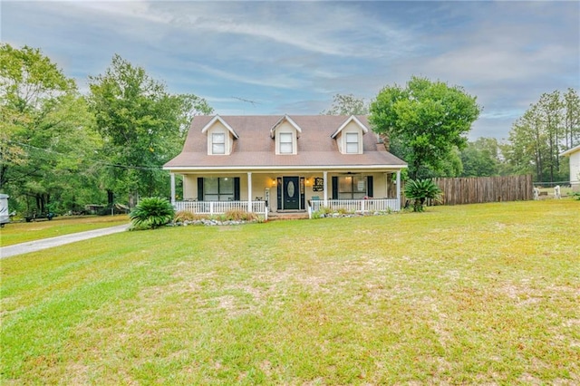 cape cod house with a porch and a front lawn