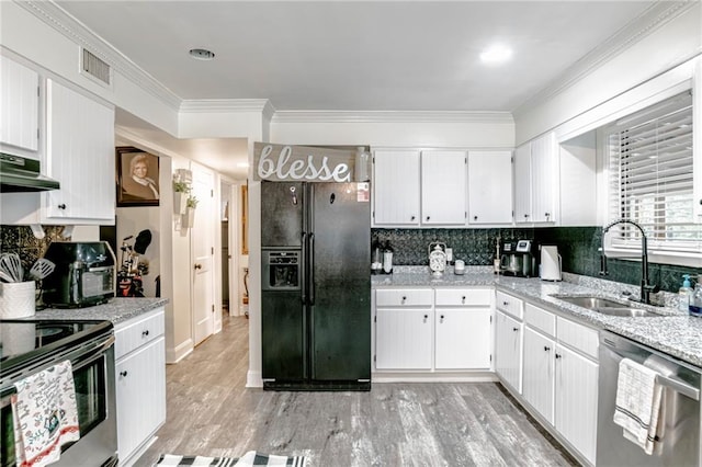 kitchen with light hardwood / wood-style flooring, sink, light stone countertops, appliances with stainless steel finishes, and white cabinets